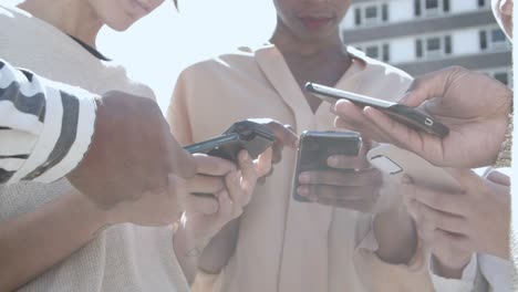 low angle view of young people using smartphones