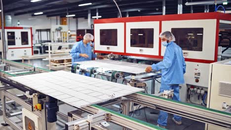innovative technologies in the modern factory. specialists in blue uniform working inside technologically advanced plant.automated equipment indoors.