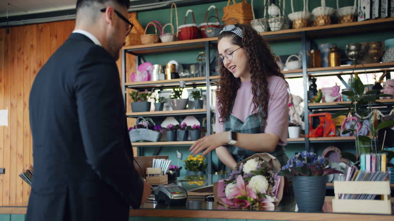 Customer paying for flowers in a flower shop