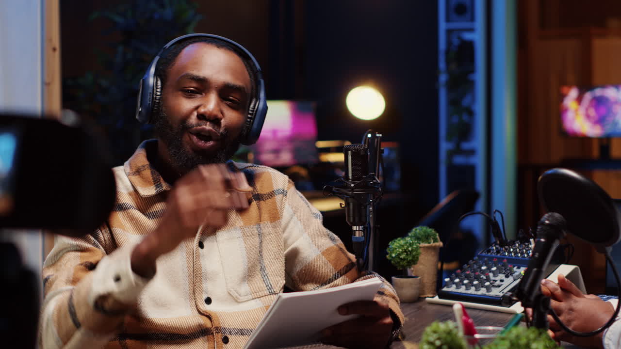 Man on podcast using recording camera while talking with guest during marathon streaming