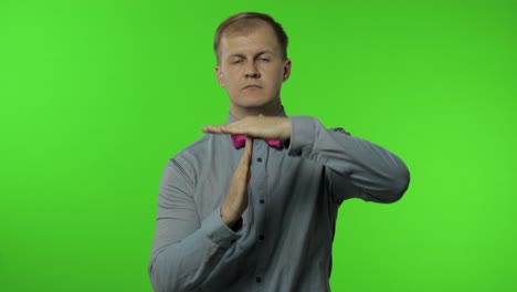 man showing time out sign. this is limit, enough gesture. portrait of guy on chroma key background