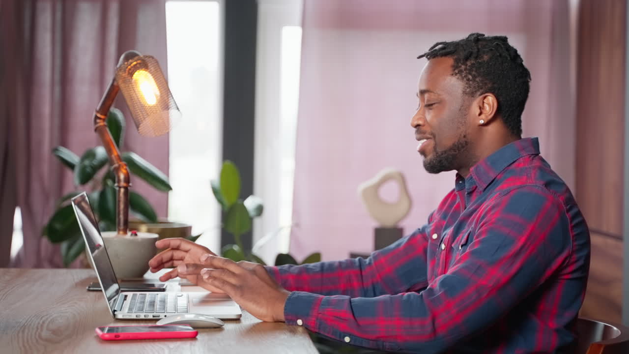 Man Working on Laptop at Home