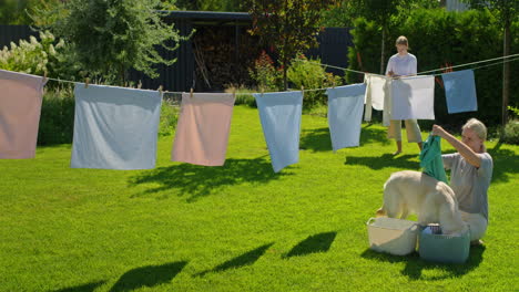 family drying clothes in the backyard