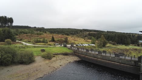 Alwen-reservoir-industrial-hydroelectric-landmark-historical-rural-lake-dam-building-aerial-pan-right-pull-away