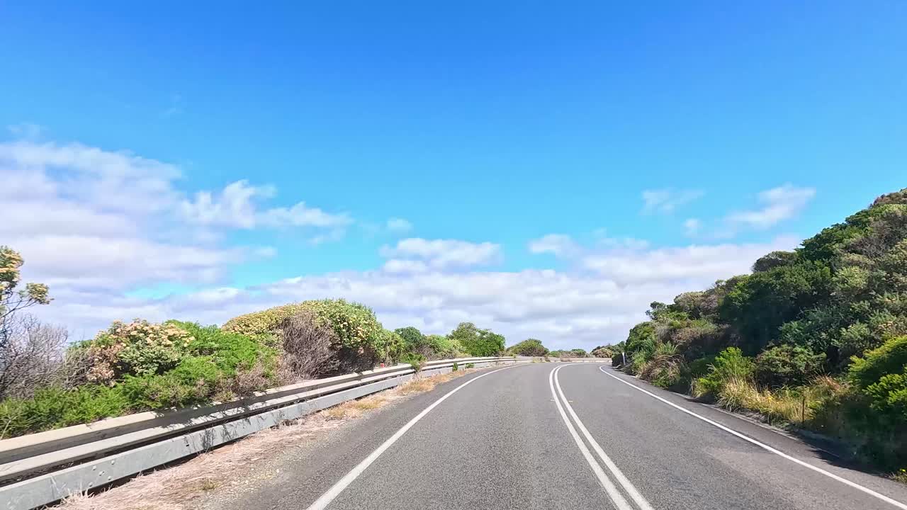 A 13-second video captures a drive along the Great Ocean Road, showcasing lush greenery, clear skies, and ocean views