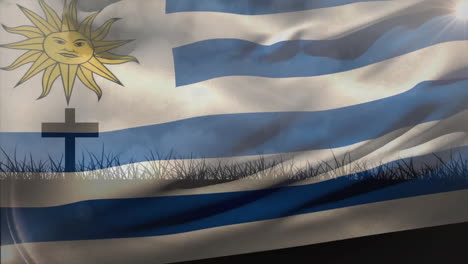 waving uruguay flag with cross and grass silhouette in foreground animation