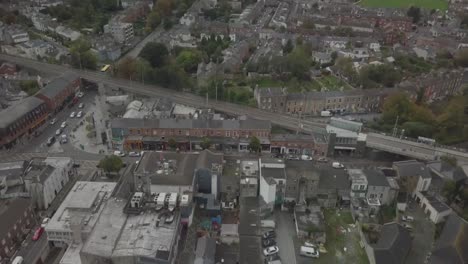 aerial shot of a suburban town-street on the outskirts of dublin city centre, some late traffic moving