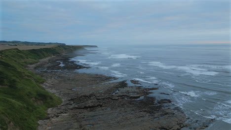 Establishing-Aerial-Drone-Shot-of-Cleveland-Way-on-Misty-Morning-at-Low-Tide