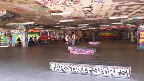 skateboarders performing tricks in urban skatepark