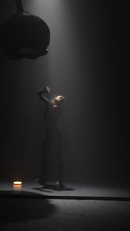 modern dance performance in a dark studio