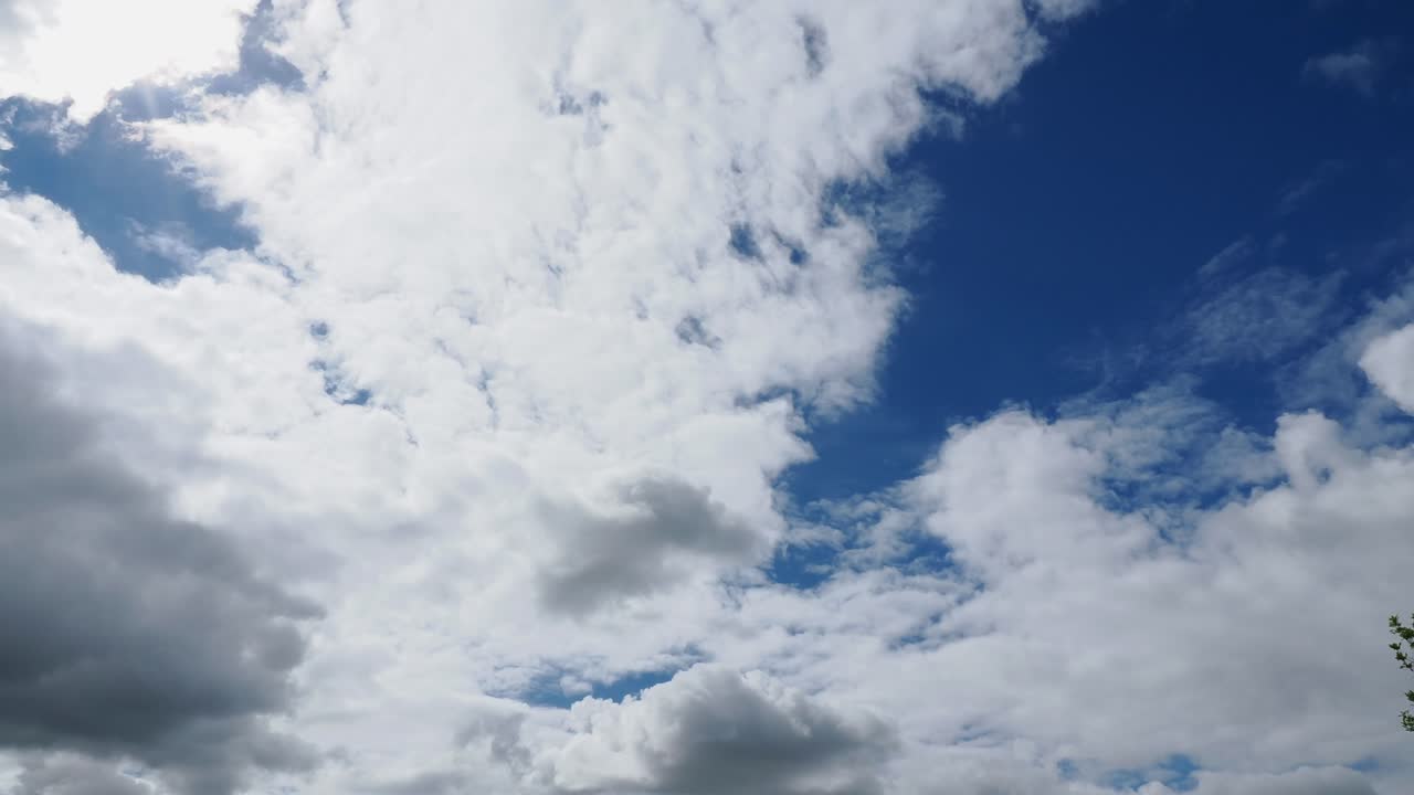 Timelapse of clouds coming and going against a blue sky