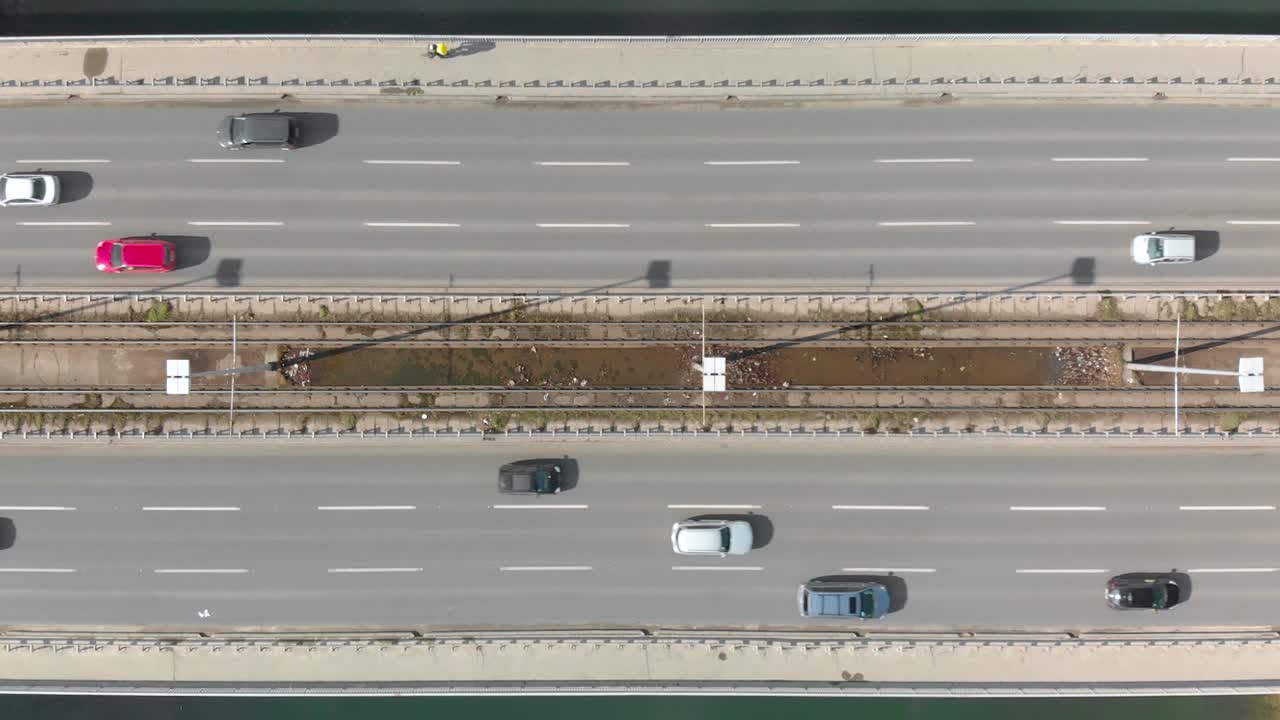 Aerial Drone Flight top down View of high way busy city traffic jam and a cyclist on bicycle lane. Car pooling natural power concept