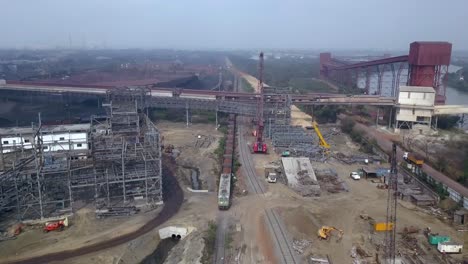 loader train running slowly in a railway in paradip port, orisha india - aerial shot