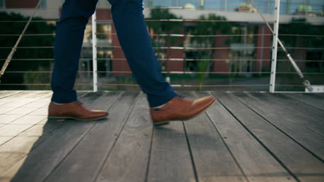 man walking on a wooden bridge