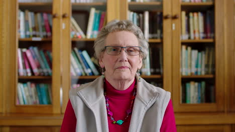 portrait of a senior woman sitting in a library to