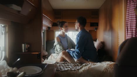 couple kissing in a camper van