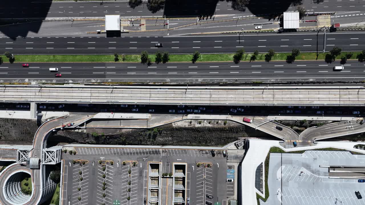 Drone shot in slow-motion of train tracks crossing Santa Fe, CDMX