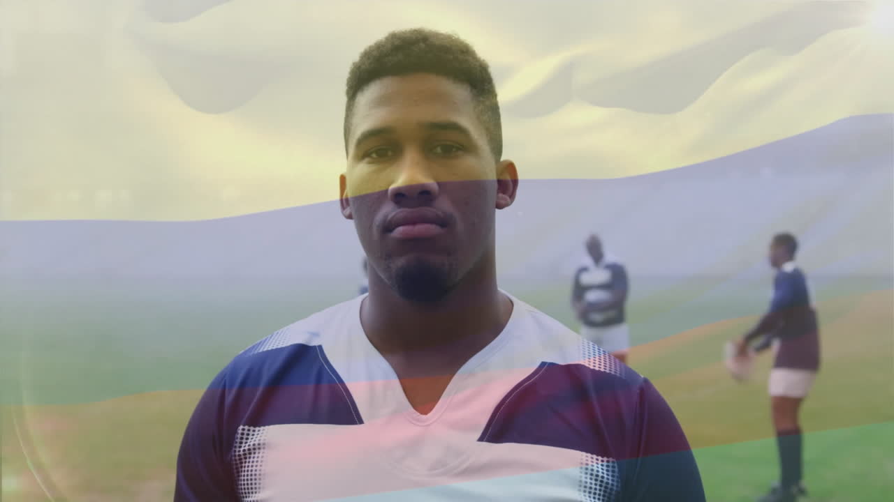 animación de la bandera de colombia sobre el retrato de un jugador de rugby afroamericano en el campo de rugby
