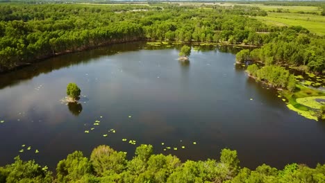 Low-and-then-rising-aerial-footage-of-the-Cattana-Wetlands-at-Smithfield,-near-Cairns,-Queensland,-Australia