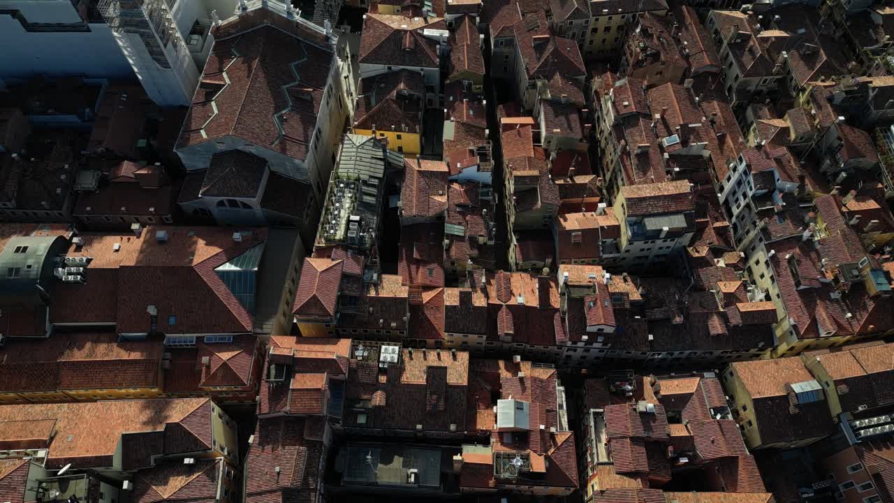 High-angle aerial view showcasing Venice's dense rooftop patterns and narrow alleys.
