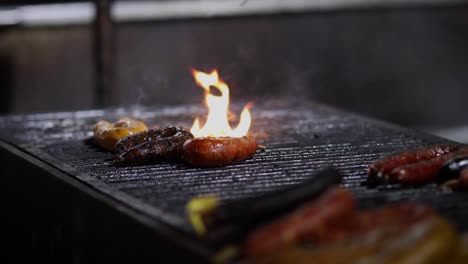 street food. portuguese traditional spicy sausage being barbecued over hot charcoal fire