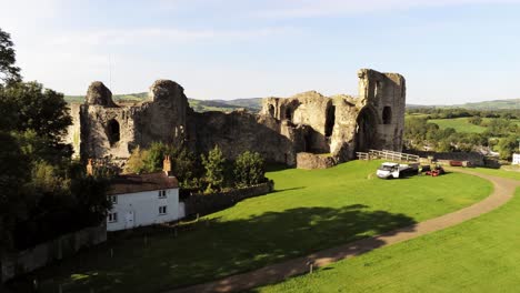 historic ancient welsh landmark denbigh castle medieval old hill monument ruin tourist attraction aerial rising reveal view across countryisde