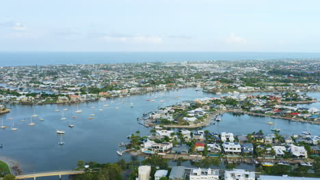 aerial drone view over mooloolaba harbour and canal with boats and waterfront homes, 4k