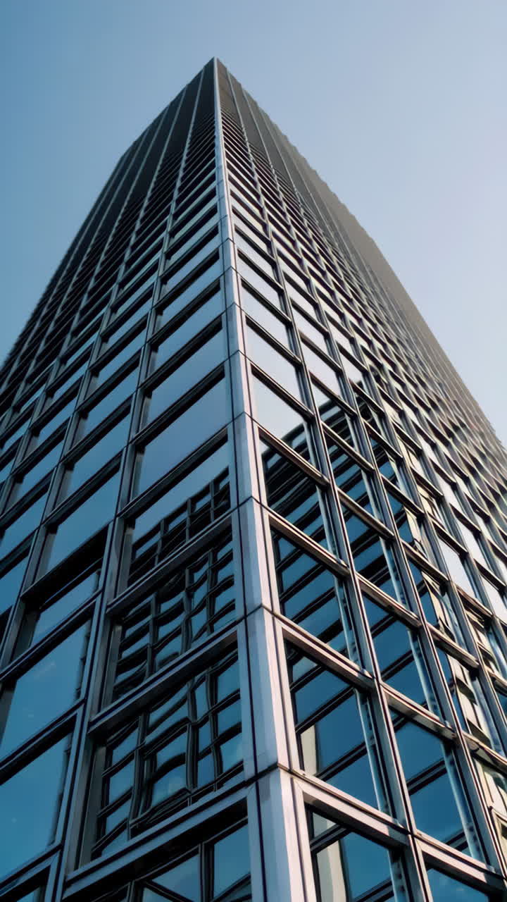 Modern Skyscraper with Glass Facade against a Blue Sky