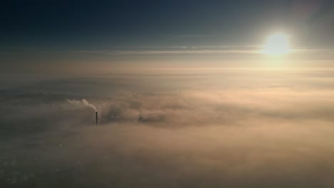 aerial drone scene above the urban townscape areas shrouded in thick morning mist