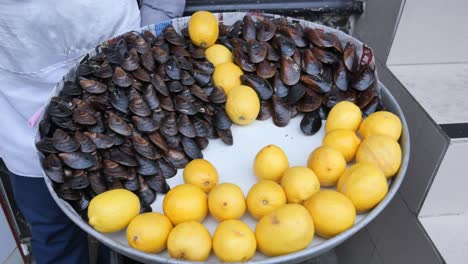 tray of grilled mussels and lemons