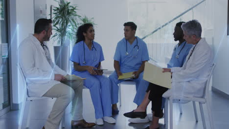 animation of heart rate montior against team of diverse doctors discussing together at hospital
