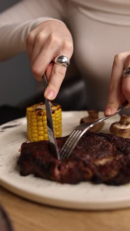 woman eating a steak dinner