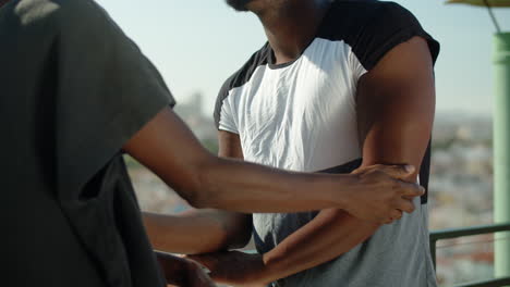 Unrecognisable gay gently touching arm of his lover outdoors