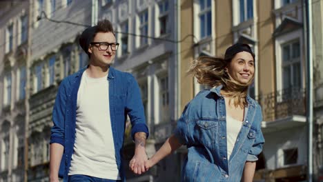 cheerful couple walking and holding hands