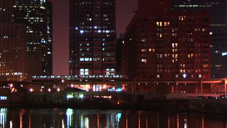 An-Elevated-Commuter-Train-Moves-Slowly-Through-Downtown-Chicago-At-Night