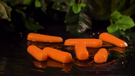 baby carrots dropped into water in slow motion