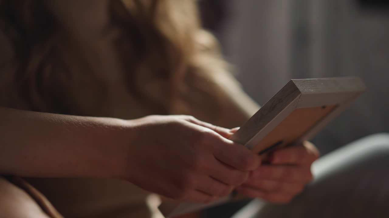 Lonely woman touches picture missing boyfriend st home