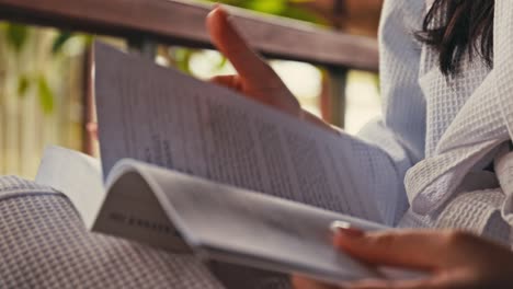 Woman-wearing-white-robe-and-reading-a-book