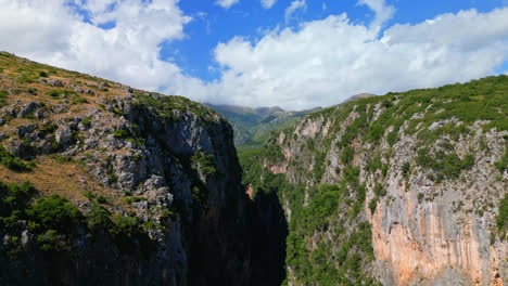 Aerial-drone-backward-moving-shot-of-canyon-along-Gjipe-Beach-in-Albania-on-a-sunny-day