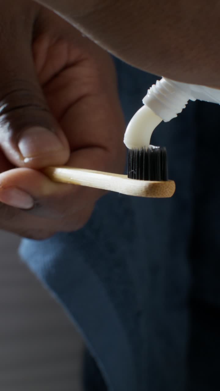 Applying Toothpaste to a Bamboo Toothbrush