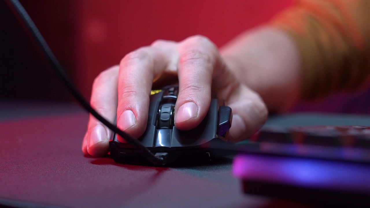 Close-up of Hand Clicking and Scrolling a Gaming Mouse with RGB Lighting
