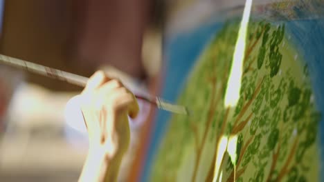close-up of a person painting a tree