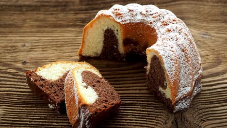 traditional homemade marble cake. sliced marble bundt cake on wooden table. 4k resolution.