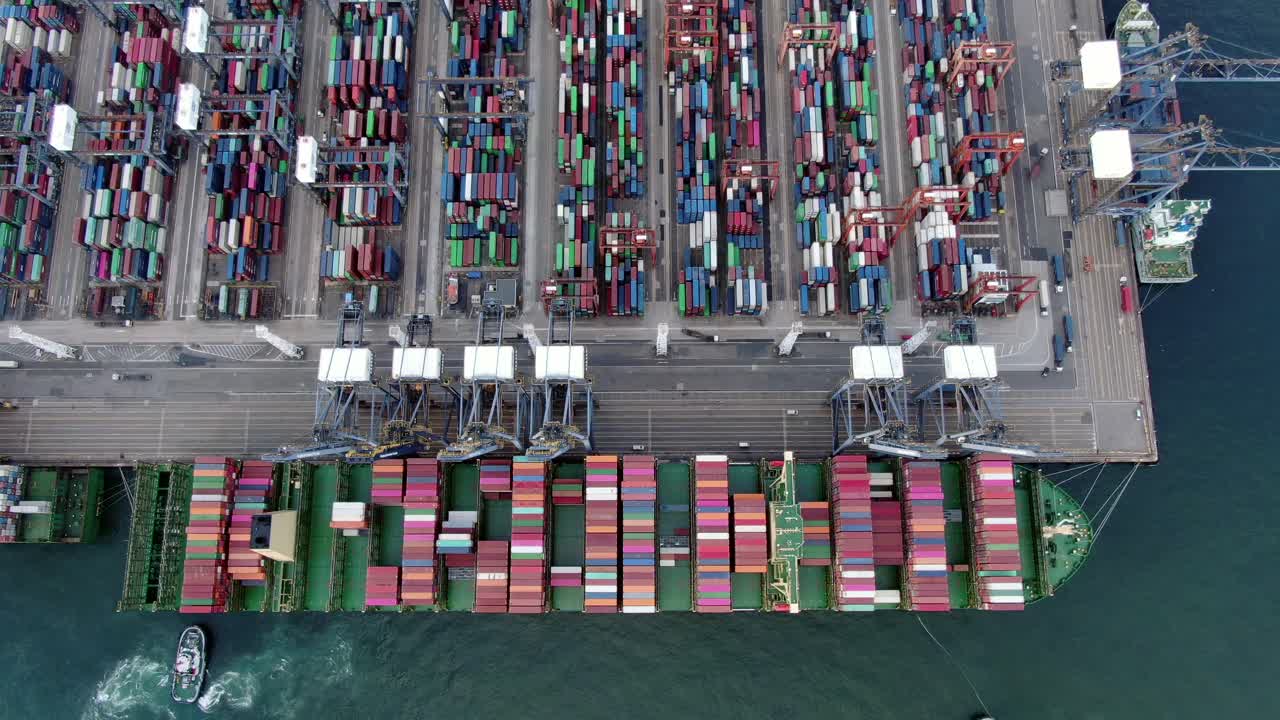 Mega Container Ship docked at Hong Kong port, during loading and unloading operation, Aerial view