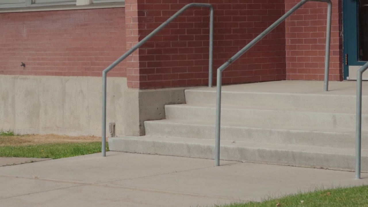 Slow forward tracking glide follows exterior stairs from right to left.