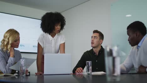 African-american-businesswoman-giving-presentation-to-diverse-group-of-colleagues-in-meeting-room