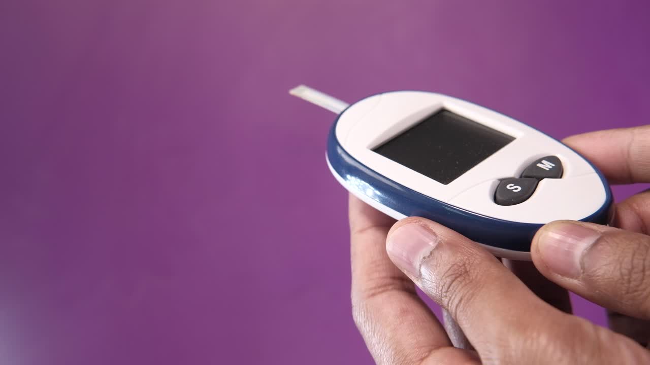 Blood Glucose Meter in Hands