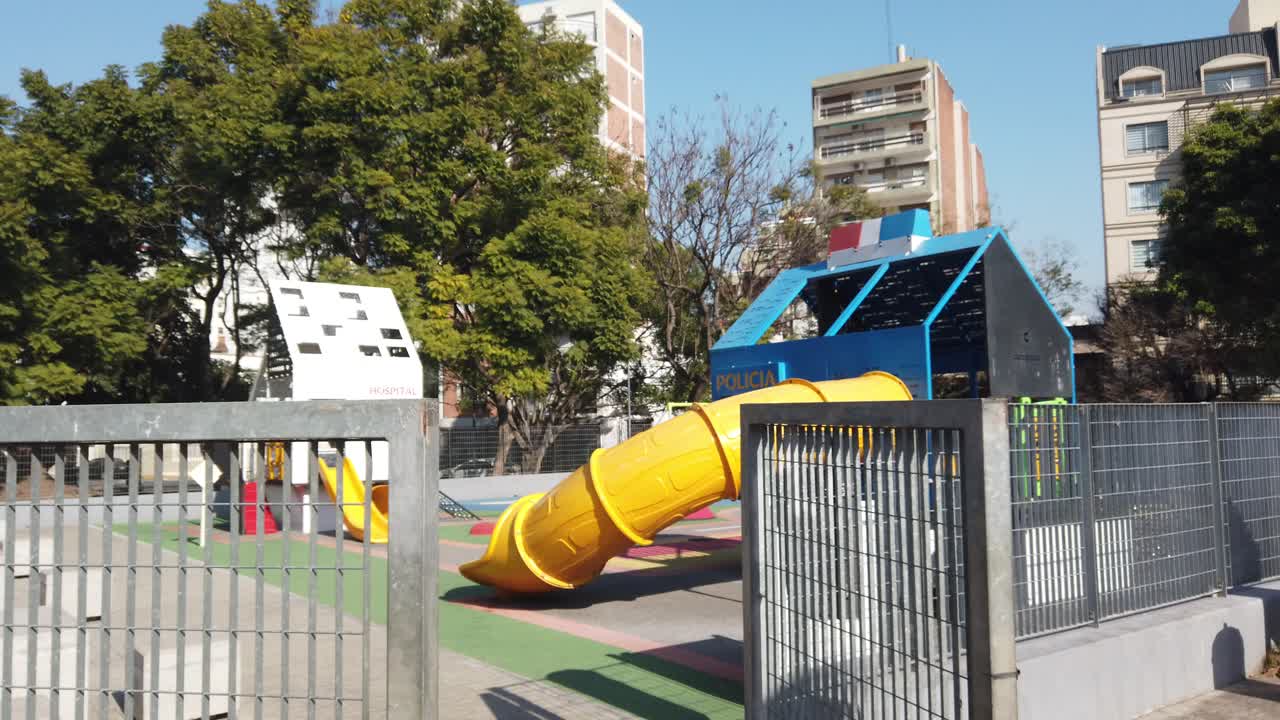 Urban park with children's playground, city buildings of Buenos Aires Argentina