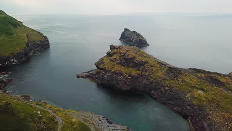 boat travelling down boscastle harbour inlet, cornwall united kingdom, aerial