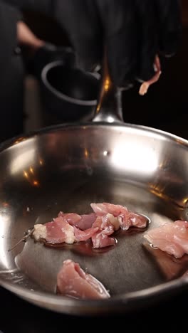 preparing raw chicken in a pan